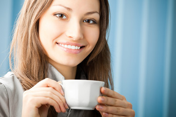 Cheerful smiling business woman with coffee