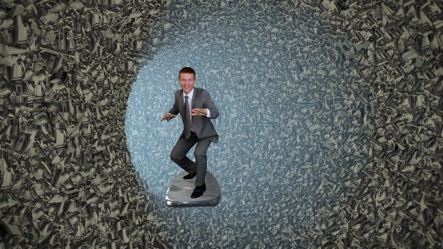 Businessman Surfing inside a Tube of Crumpled US Dollars