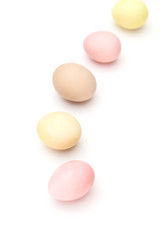 Rainbow of motley hen's eggs, isolated on white