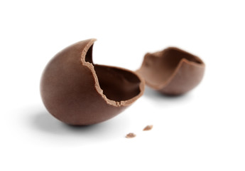 Cracked chocolate egg, isolated on white