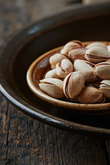 Pistachios on a dark ceramic plate