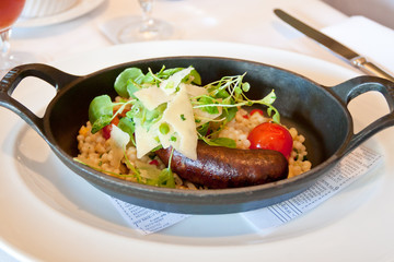 Grilled lamb merguez sausage with fregola, cress and  parmigiano