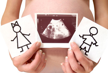 The pregnant woman holds drawings of the boy and the girl and a