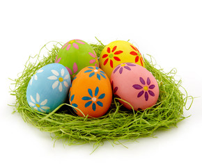 Nest of colorful Easter eggs on white background