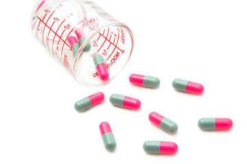 Pills from bottle on the white