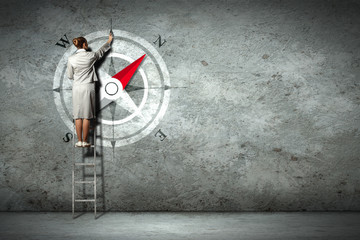 Business woman drawing compass