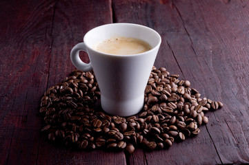 cup of coffee on brown, old wooden background