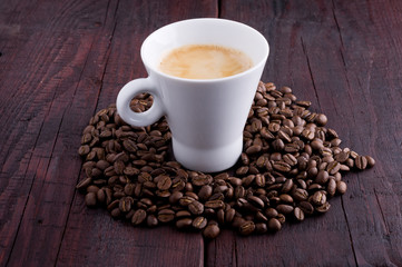 cup of coffee on brown, old wooden background