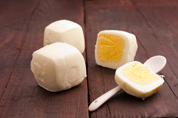 square, peeled eggs on old wooden planks