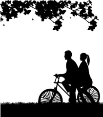 Couple bike ride in park in spring silhouette