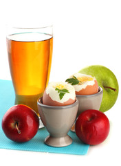 Light breakfast with boiled eggs and glass of juice, isolated