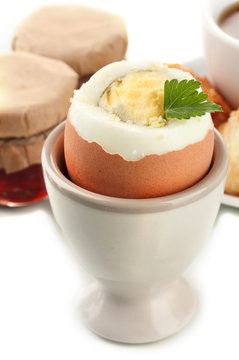 Light breakfast with boiled egg and coffee, isolated on white