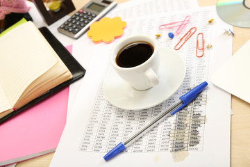 Cup of coffee on office desktop close-up