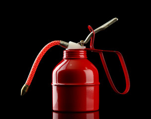 Oil can on black background