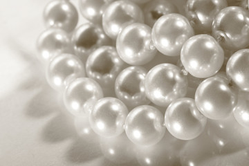 White pearl on reflective surface © Sergey Yarochkin