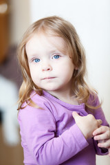 Portrait of a sweet young happy girl looking at camera