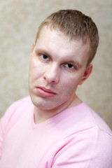 Closeup of handsome man looking at camera with serious look