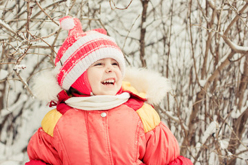 Obraz premium Beautiful happy kid in the red jacket