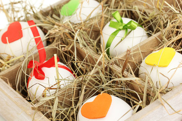 Decorative Easter eggs in wooden basket close up