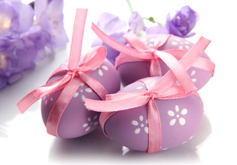 Bright easter eggs with bows and flowers, isolated on white