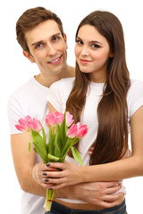 Loving couple with tulips isolated on white