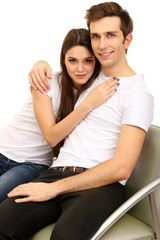 Young couple sitting together isolated on white