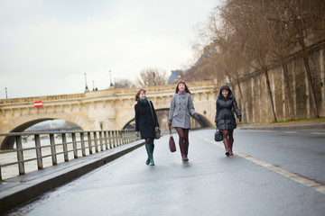 Three joyful girls walking in Paris
