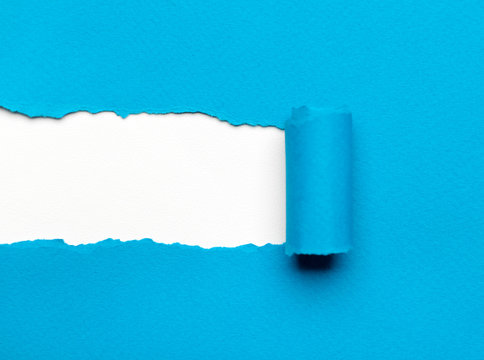 Torn light blue paper with white copyspace 