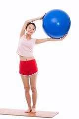 Young woman with gym ball isolated on white