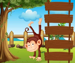 Papier Peint photo autocollant Zoo Un singe à côté des panneaux en bois vides
