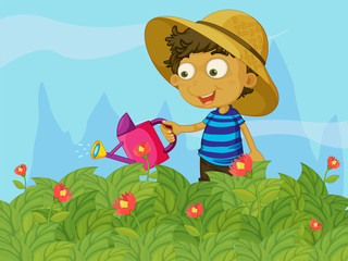 Un garçon arrosant les plantes dans un jardin