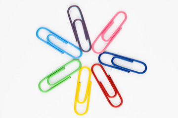 colorful paper clips in white background