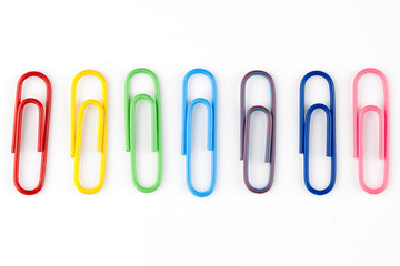 colorful paper clips in white background