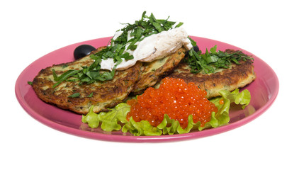 Roasted cutlets of potato with salmon on a plate