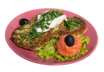 Roasted cutlets of potato with salmon on a plate