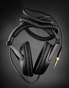 Modern headphones over dark background