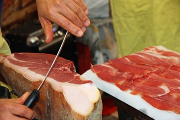 butcher knife cut large slices of enticing ham to sell