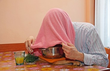 man with pink towel breathe balsam vapors