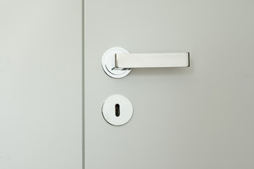 detail of white doors with chrome handle - obrazy, fototapety, plakaty