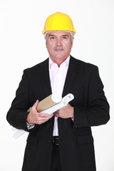 Senior architect carrying plans