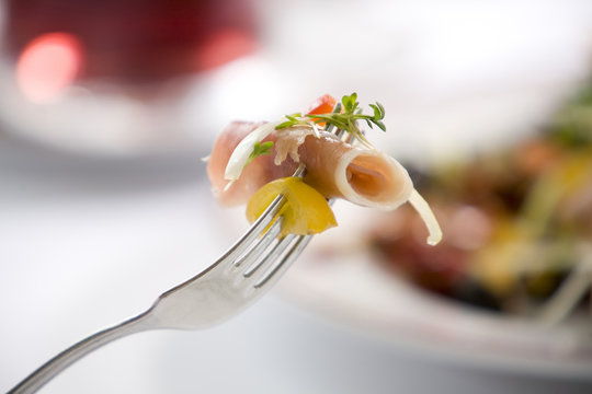 delicious prosciutto titbit on a fork