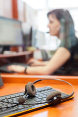 call center with young woman headphones 