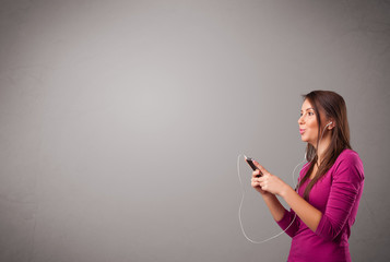 young lady singing and listening to music with copy space