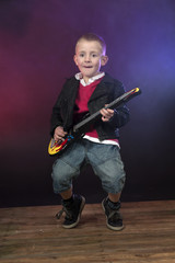 boy on stage with guitar