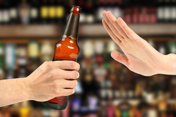 hand reject a bottle of beer in the bar - obrazy, fototapety, plakaty
