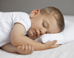 Cute child is sleeping in bed