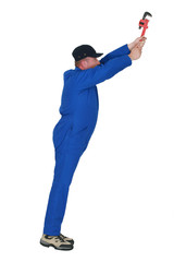 Naklejka premium Plumber with wrench reaching upwards