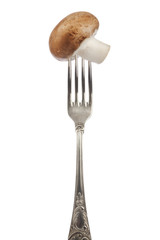 brown edible mushroom on silver fork
