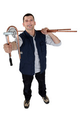 Man using copper pipe bending tool