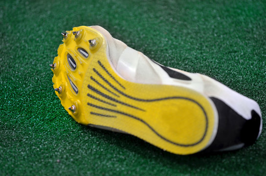 Running Shoes Spikes on Green Turf